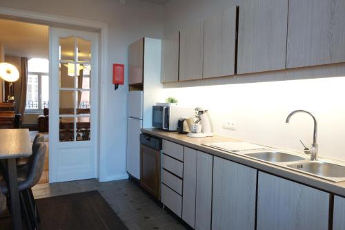 a kitchen with a sink and a counter top at Temps de Pose in Ypres