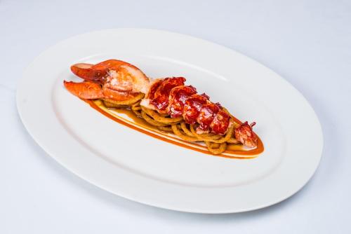 a plate of food with shrimp on a white plate at Vaughans Anchor Inn in Liscannor