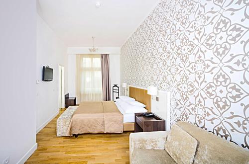 a hotel room with a bed and a couch at Deminka Palace in Prague