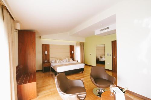 a hotel room with a bed and two chairs at Hotel Jana in Međugorje