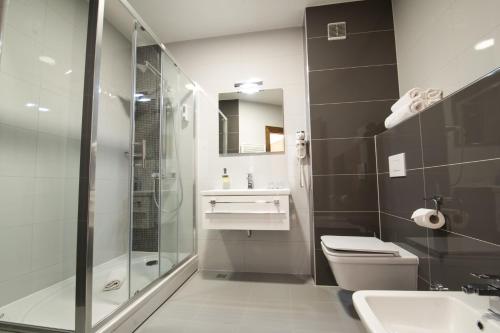 a bathroom with a shower and a toilet and a sink at Hotel Jana in Međugorje