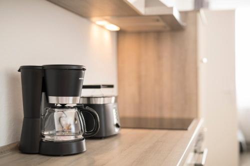 a coffee maker sitting on a counter in a kitchen at GWG City Apartments III in Halle-Neustadt