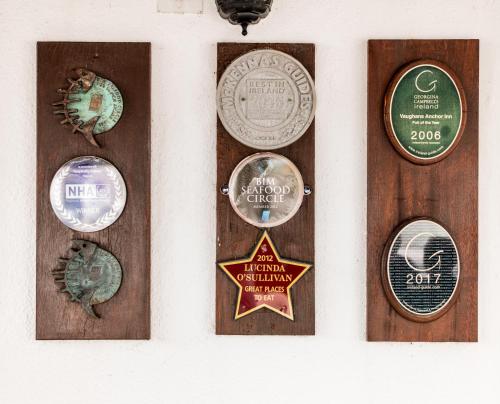 four different types of medals on a wall at Vaughans Anchor Inn in Liscannor