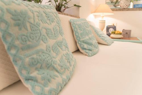 a bed with two pillows on top of it at Hotel Terranova in Olbia