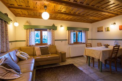 a living room with a couch and a table at Penzion Mayer in Bled