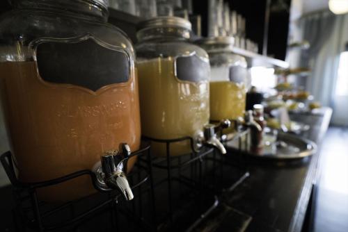 a row of jars filled with orange juice on a counter at Grand Hotel Jonkoping, BW Signature Collection in Jönköping