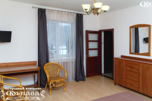a living room with a mirror and a chair at Hotel Complex Kupava in Podvorki