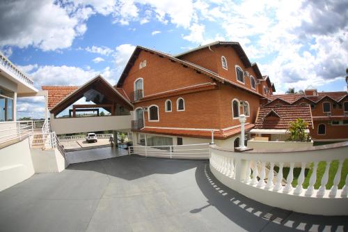 a large house with a balcony and a building at Hotel Mansão dos Nobres in São João da Boa Vista