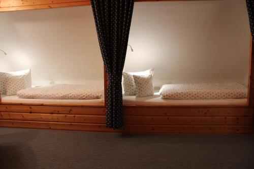 two bunk beds in a room with curtains at Haus Kleemann in Norderney