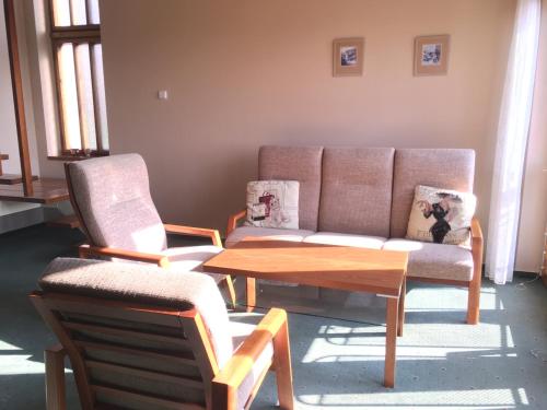a living room with a couch and two chairs and a table at Pension Apartment Granit in Prague