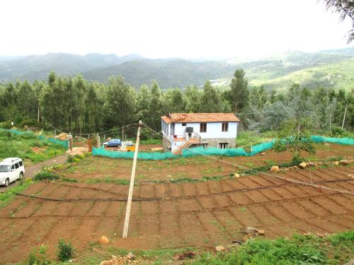 a house in the middle of a field at Relaxing 2 B/R Estate House, Deenaty, Tamil Nadu in Coimbatore