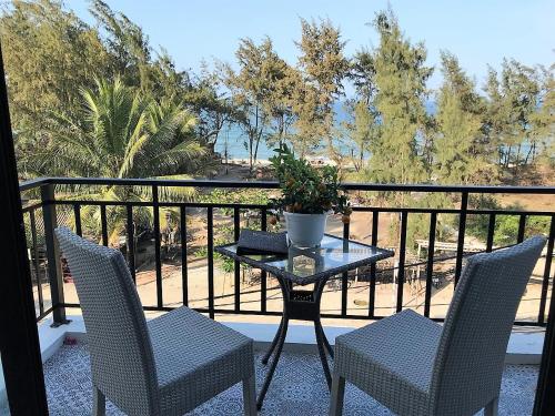 a table and two chairs on a balcony at Santa Sea Villa in Hoi An