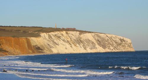 a group of people in the water at the beach at The Havelock in Shanklin