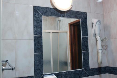 a bathroom with a mirror and a sink at Mikotania in Covilhã