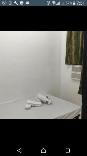 a white table with a phone on top of it at Prince Transient house in San Jose