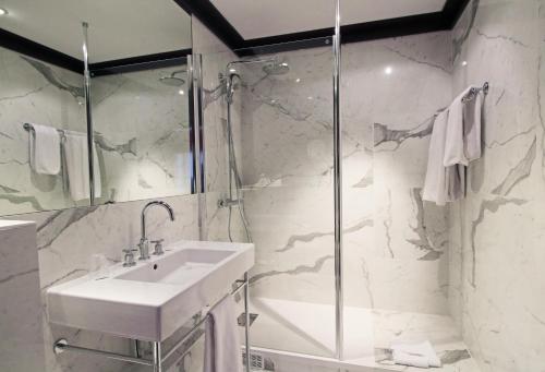 a bathroom with a sink and a shower at Grand Hotel de l'Opera - BW Premier Collection in Toulouse