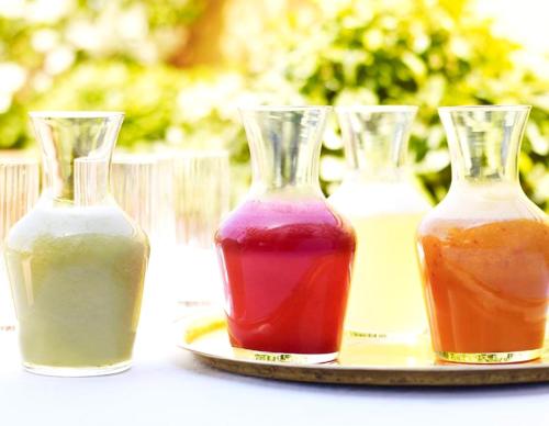 three vases of different colored liquids on a plate at Riad L'H&ocirc;tel Marrakech in Marrakesh