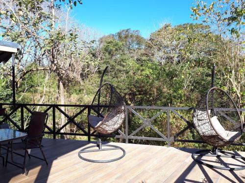 two chairs and a table on a deck at Chalet San Juanillo in San Juanillo