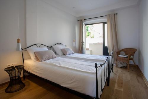 a large bed in a room with a window at Bella Vista Suites in Vis