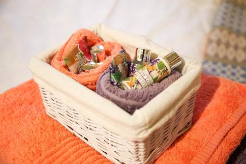 a basket filled with towels on an orange blanket at Storws Y Gorlan Shepherd's Hut in Valley