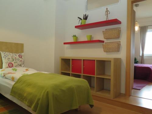 a bedroom with a bed and a fireplace at Apartmán Penzák in Vysoké Tatry