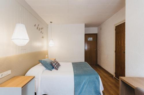 Ένα ή περισσότερα κρεβάτια σε δωμάτιο στο Hotel Catalunya Ribes de Freser