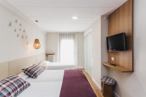 Postel nebo postele na pokoji v ubytování Hotel Catalunya Ribes de Freser
