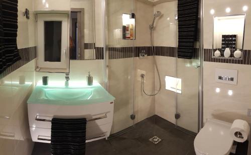 a bathroom with a sink and a shower at Villa Gina in Sevid