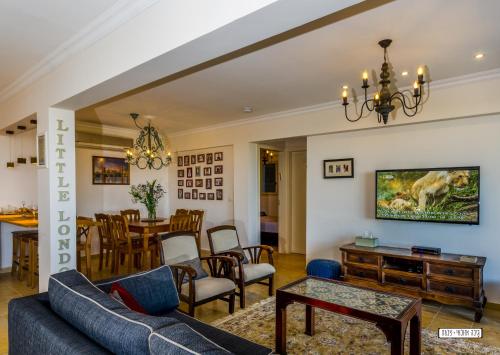 a living room with a couch and a table at Naomi's in Rosh Pinna