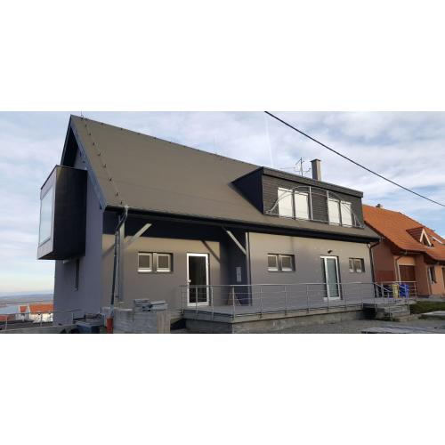 a large house with a black roof at VilaPavlov in Pavlov