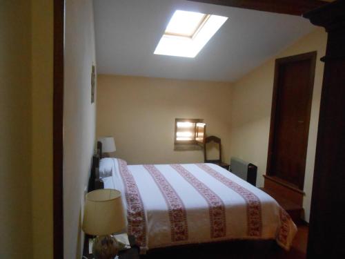 a bedroom with a bed and a skylight at Lo Spedalicchio in Bastia Umbra