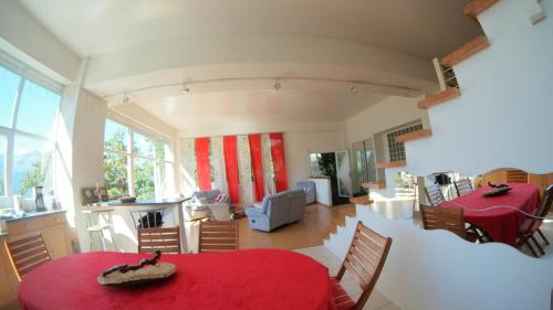 a living room with a red table and chairs at GLMB - Location Mont-Blanc in Saint-Gervais-les-Bains