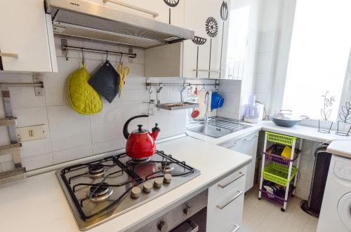 a kitchen with a stove with a tea kettle on it at RotApartment - Monza in Monza