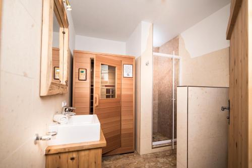 a bathroom with a sink and a shower at Chalets Steiner in Hart im Zillertal