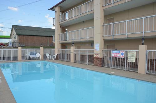 a large swimming pool in front of a building at Days Inn by Wyndham Airport Nashville East in Nashville