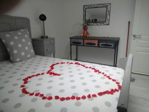 a bed with a heart made out of red roses at Le Clos du Square - climatisé in Rochefort