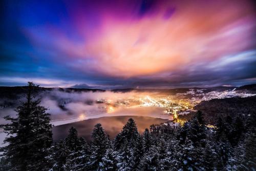 a view of a city in the snow at night at LE QUARTZ DES HAUTES-VOSGES in Xonrupt-Longemer