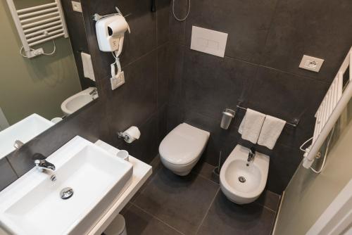 a bathroom with a white toilet and a sink at Residence del sole Manfredonia in Manfredonia