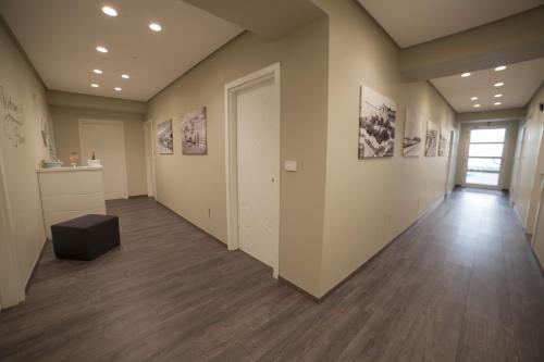 an empty room with a hallway with paintings on the walls at Residence del sole Manfredonia in Manfredonia