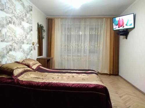 מיטה או מיטות בחדר ב-Apartment on Kuybysheva 59
