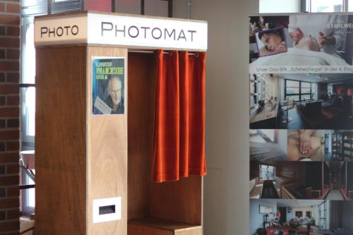a display of a photo booth with red curtains at Altes Stahlwerk Business & Lifestyle Hotel in Neumünster