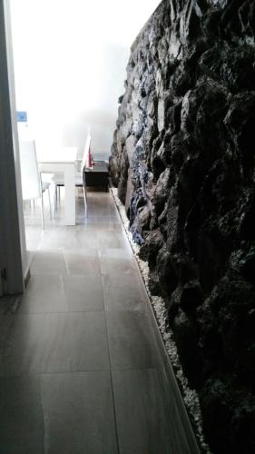 a stone wall in a dining room with a table at VILLA Atlantico Views in Candelaria