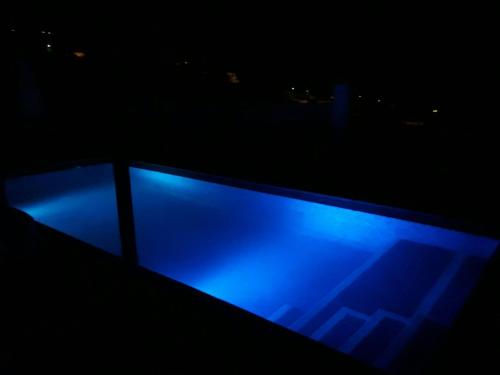 a blue light on a balcony at night at VILLA Atlantico Views in Candelaria