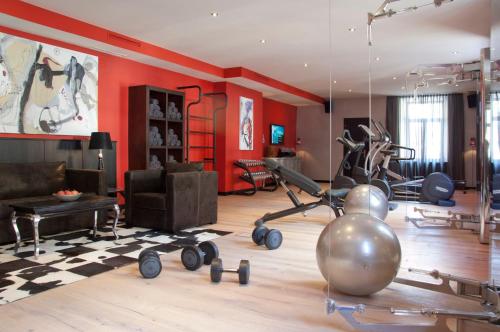 a living room with a gym with exercise equipment at Cortisen am See - Adults only in St. Wolfgang