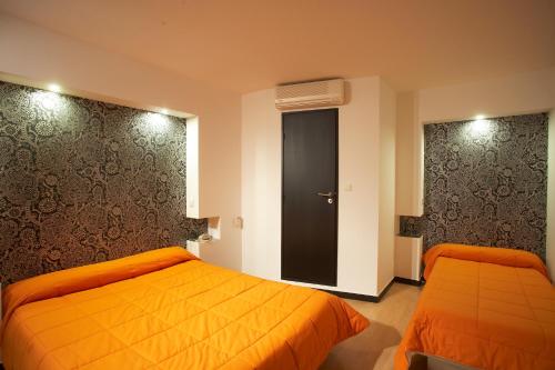 Postel nebo postele na pokoji v ubytování Hôtel Evan