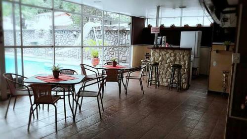 a kitchen with a dining room table and chairs at Pousada Praia da Costa in Vila Velha
