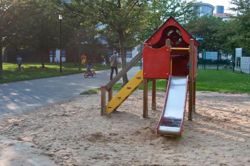 a playground with a slide in a park at GWG City Apartments III in Halle-Neustadt