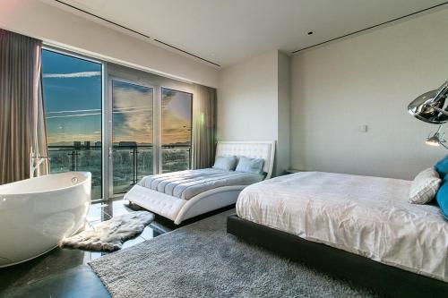 a bedroom with two beds and a large window at Dream Penthouse at Palms Place in Las Vegas
