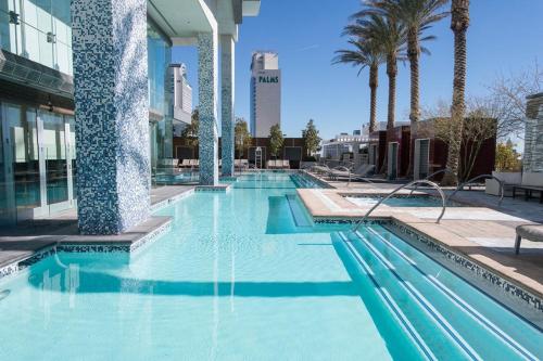 a swimming pool with a fountain in front of a building at Dream Penthouse at Palms Place in Las Vegas