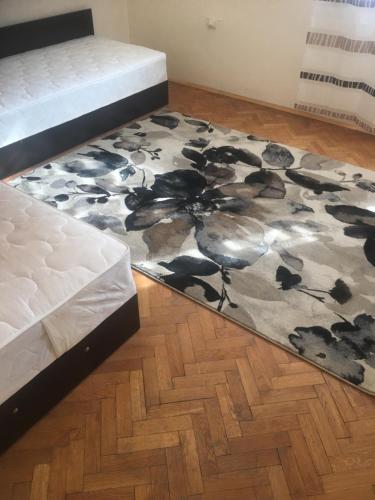 a rug on the floor next to a bed and a mattress at Stylish spacious flat in Sofia